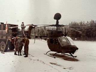 Steve with soldiers by a helicopter